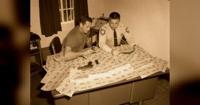 A Monroe County Deputy looking at fake Cuban lottery tickets C 1960.
